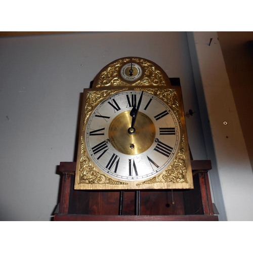 2452 - A mahogany cased 8 day brass dial Grandfather clock with inlaid door and base.