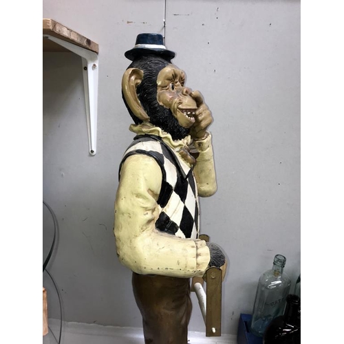 1037 - A painted resin monkey being a fun toilet roll holder, height 80cm