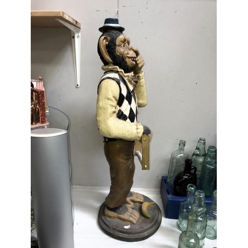 1037 - A painted resin monkey being a fun toilet roll holder, height 80cm