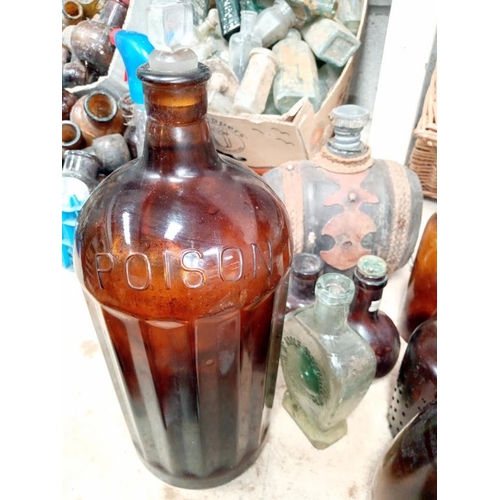 11 - A collection of brown/clear bottles with a large chemist poison bottle