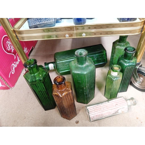 16 - 3 shelves of blue, green & clear bottles of various sizes with 'not to be taken' on