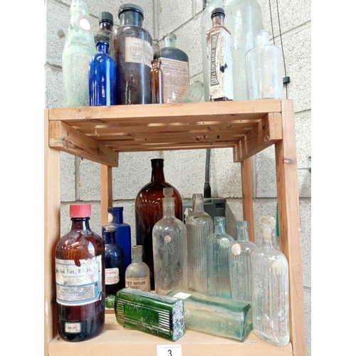 3 - 3 shelves of decorative bottles, some marked poison