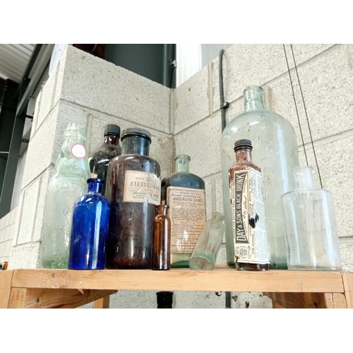 3 - 3 shelves of decorative bottles, some marked poison