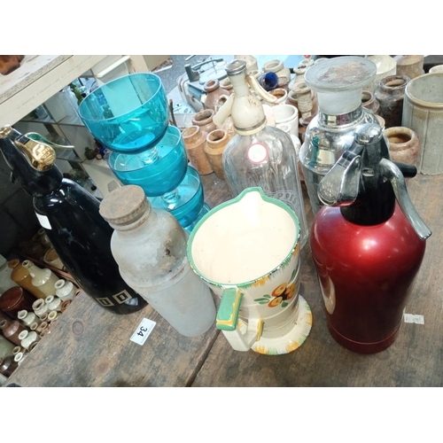 34 - A collection of 50's/60's soda syphons, shakers & jug etc.