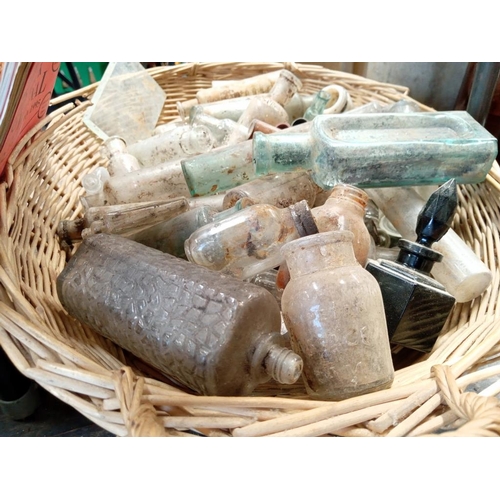 36 - A wicker basket of potion bottles, a Cockington glazed mug 7 a lot of 'bottle club' magazines