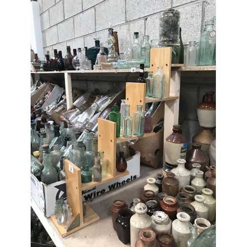 9 - A shelf of potion bottles & a jar of lids