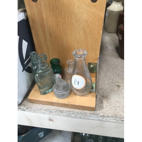 9 - A shelf of potion bottles & a jar of lids