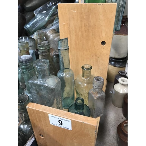 9 - A shelf of potion bottles & a jar of lids