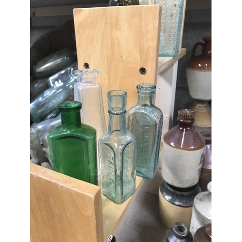 9 - A shelf of potion bottles & a jar of lids