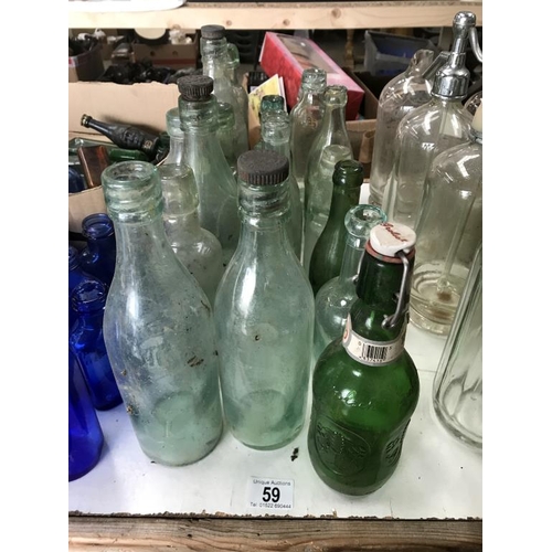 59 - A large lot of clear 'local area' bottles