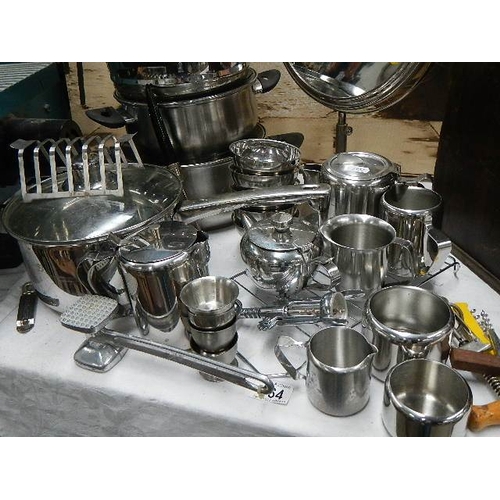 164 - A mixed lot including stainless steel pans, jugs etc.,