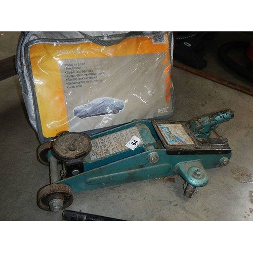 64 - An old car jack and a car blanket.