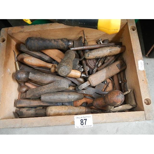 87 - Two boxes of old tools including saws.