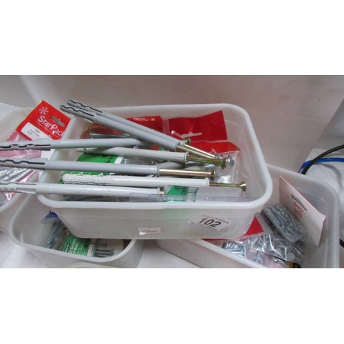 102 - Six tubs of nails, wall anchor sets etc.,