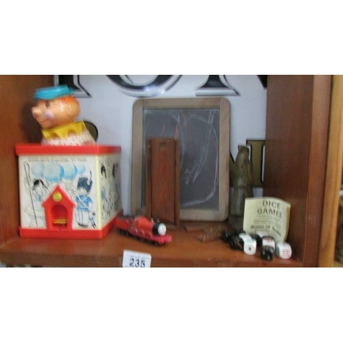 235 - A mixed lot of vintage toys, money boxes etc.,