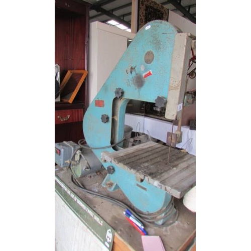 336 - A bench bandsaw on bench with spare bands etc., (Collect only)