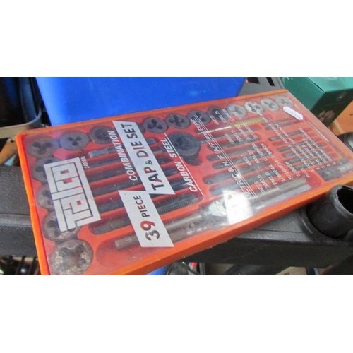 47 - A shelf full of gloves/straps/clamps/ u bolts and a tap and die set.