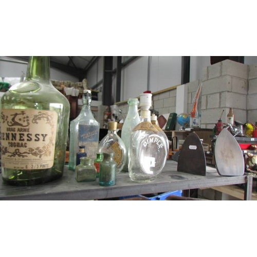 89 - Two shelves of miscellaneous bottles, tools, vice etc.,