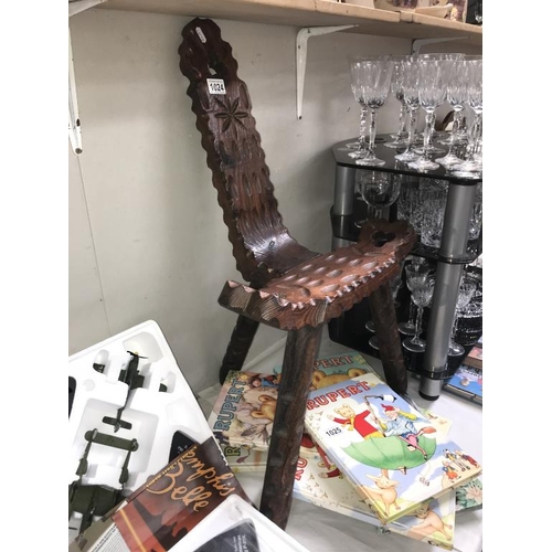 1024 - A carved dark wood spinning chair.  (Collect only)