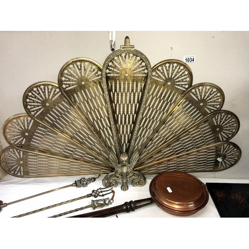 1034 - A selection of brass & copper including Peacock/fan fire screen, toasting forks & large heavy cannon... 