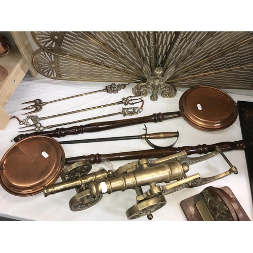 1034 - A selection of brass & copper including Peacock/fan fire screen, toasting forks & large heavy cannon... 