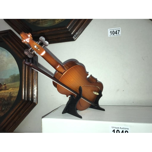 1048 - A musical double bass on stand - length approximately 25cm