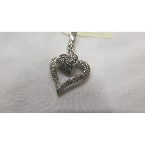 2044 - A white gold moveable diamond heart pendant.