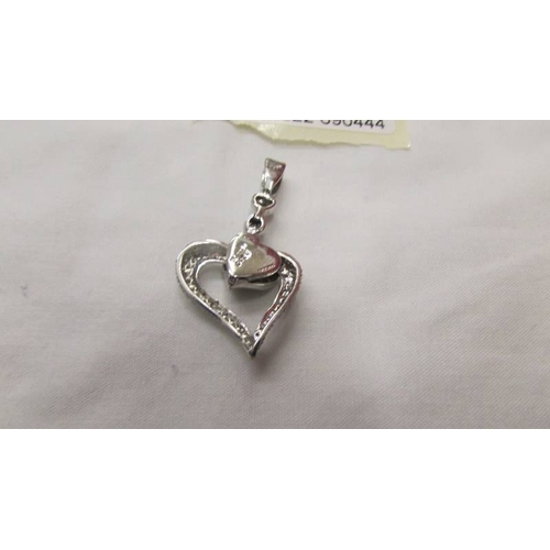 2044 - A white gold moveable diamond heart pendant.