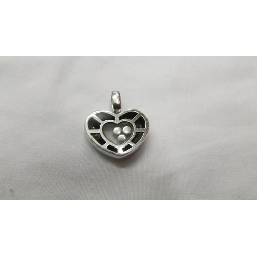 2045 - A white gold floating diamond heart pendant.