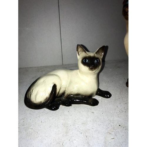 1073 - A Royal Doulton Siamese cat, Sylvac cat (some crazing to back) & Beswick Siamese cat (hairline crack... 