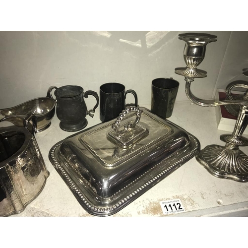 1112 - A large selection of silver plate including tureen, candelabra, part tea set & trays etc. (2 shelves... 