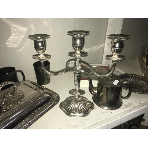 1112 - A large selection of silver plate including tureen, candelabra, part tea set & trays etc. (2 shelves... 