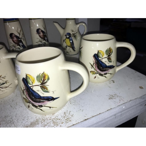 1125 - A quantity of Brixham pottery bird decorated pottery including 4 mugs, salt & pepper & vinegar & bel... 