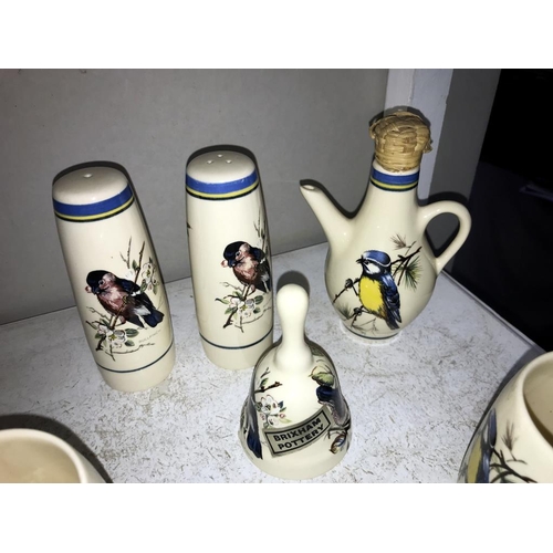 1125 - A quantity of Brixham pottery bird decorated pottery including 4 mugs, salt & pepper & vinegar & bel... 