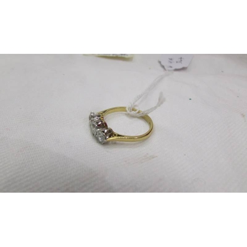 2006 - A 14ct gold three stone diamond ring, (1 carat diamonds in total, 1  half carat and 2 x quarter cara... 