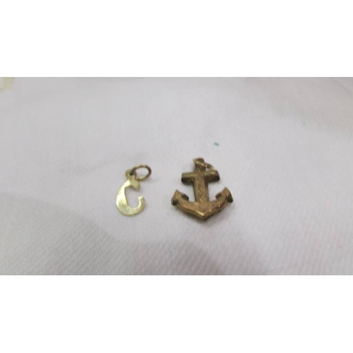 2009 - Four items of 9ct gold being an anchor, an ingot, a ring and a letter C pendant, 4.4 grams.