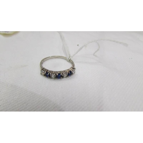 2035 - A silver ring set with blue and white stones, size Q half.