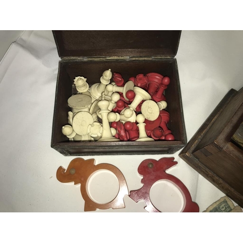 1133 - A vintage red & white chess set (missing King), 2 Bakelite animal napkin rings & a box of old coins