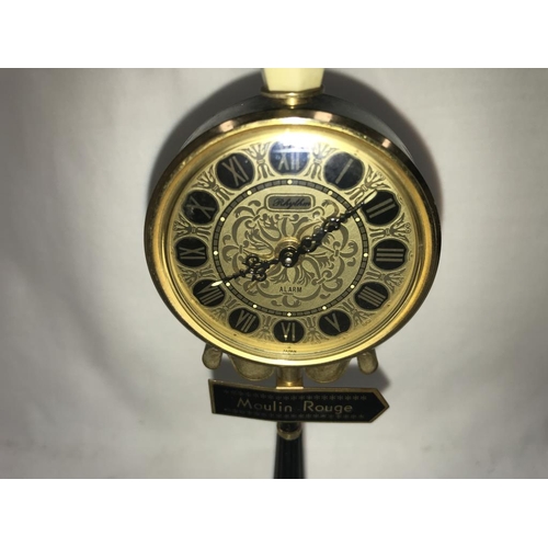 1143 - A vintage Rhythm alarm clock in form of a Moulin Rouge street lamp