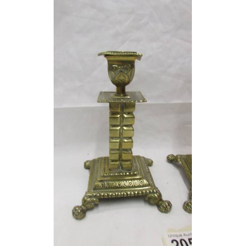 2057 - A pair of 19th century brass candlesticks on square footed bases with cubed columns.