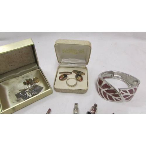 2068 - A good lot of cuff links, tie clips, silver ring and bangle.