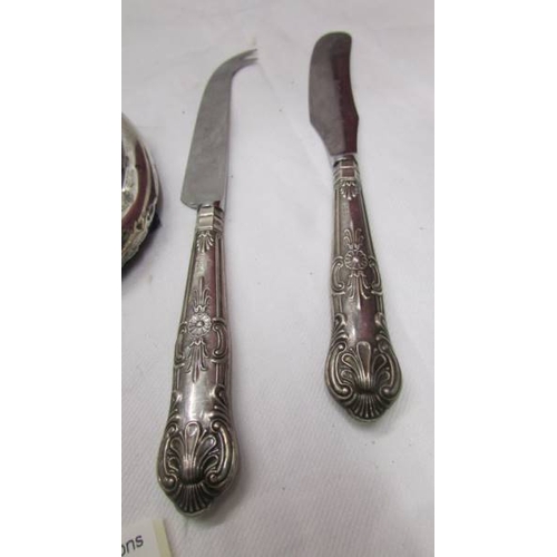 2071 - A silver handled cheese knife, a silver handled butter knife, an oval silver photo frame (a/f), a si... 