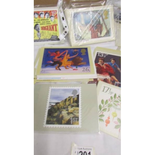 2201 - In excess of 200 assorted postcards, stamped envelopes etc.,