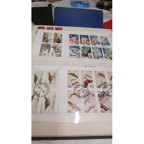 2216 - Four folders of assorted world stamps.