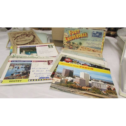 2220 - Two small albums of postcards and a box of postcards.