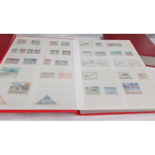 2221 - Four albums of world stamps including Poland, Iraq, USA, Australia, Fiji, Samoa, Vietnam, Malta, Bru... 