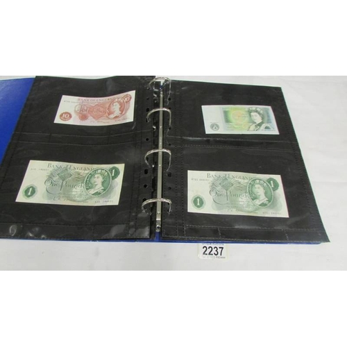 2237 - An album of bank notes including UK £1, UK 10/-, USA, Japan, Germany, France, Malaya etc.,