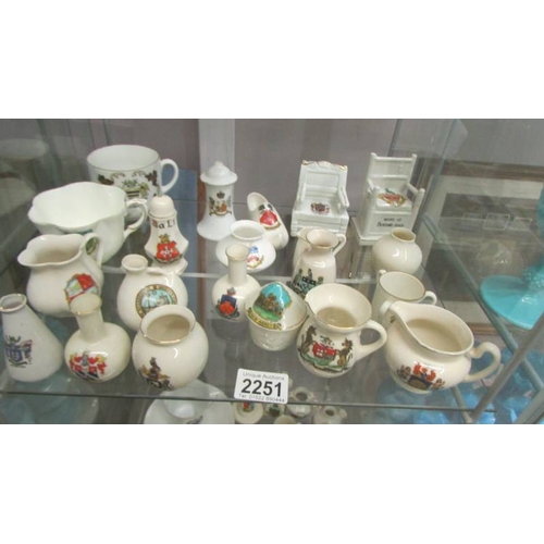 2251 - In excess of 60 pieces of crested china, various makers and locations, (3 shelves). (Collect only)