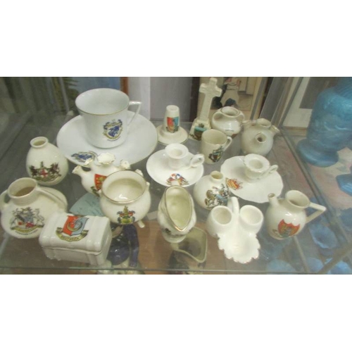 2251 - In excess of 60 pieces of crested china, various makers and locations, (3 shelves). (Collect only)