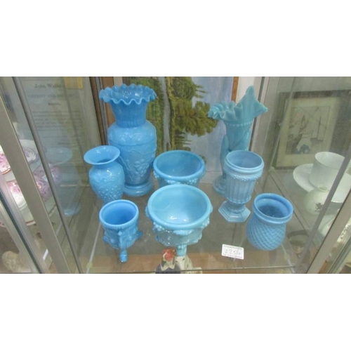 2254 - A mixed lot of blue glass including lidded bowls, vases, pots etc., 15 items in total (2 shelves). (... 